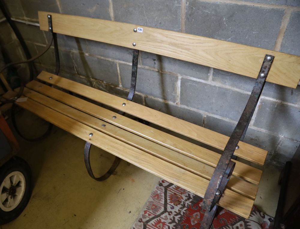 A Victorian wrought iron and ash garden bench with later slatted seat, length 155cm, depth 70cm, height 82cm